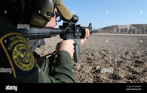 A Border Patrol Agent Shoots An M 16 Rifle During Weapon Qualifications