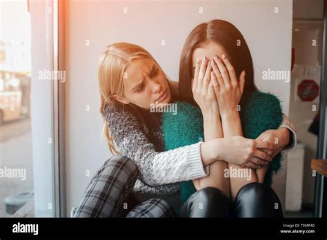 Troubled Young Girl Comforted By Her Friend Woman Supporting The Girl