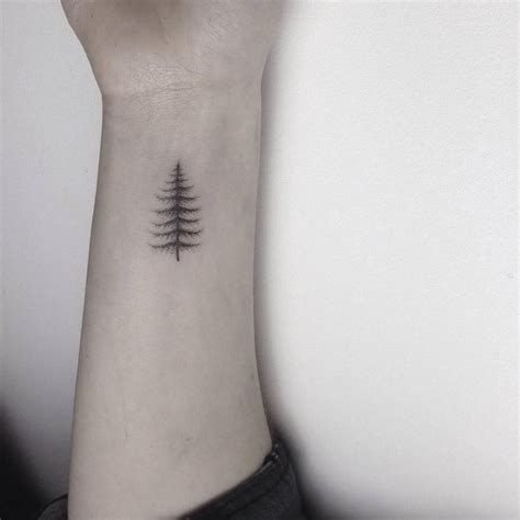 Hand Poked Small Pine Tree Tattoo On The Left Inner