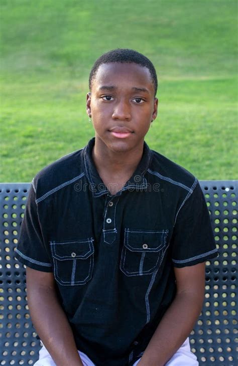 Black Teen Boy Looks Serious Stock Photo Image Of Grass Student