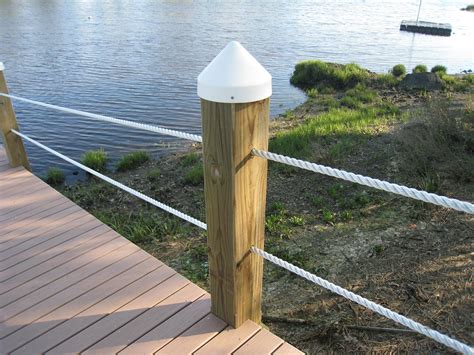 Closeup Of A Round Cone Piling Cap Secured To A Square Wooden Dock Post Give Us A Call When You