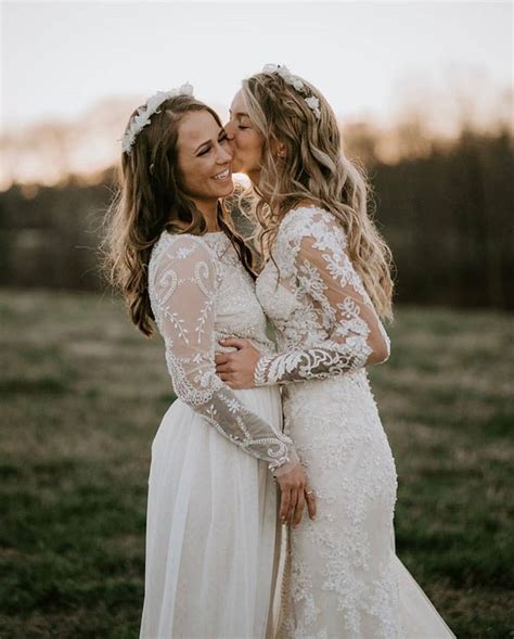 Two Women In Wedding Dresses Kissing Each Other