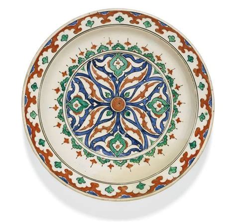An Iznik Polychrome Pottery Dish With Burst Flowerhead And Arabesques