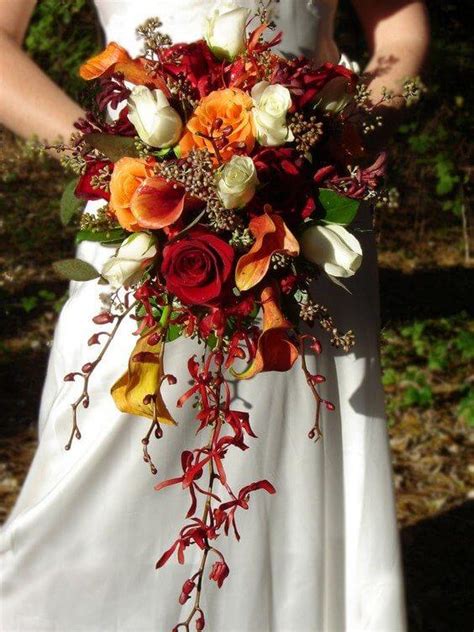 Sara's bridal bouquet, by urban chateau floral, included astilbes, maple leaves, dahlias, rice flowers, roses, baby artichokes, hypericums, and snowberry in soft shades of purple. Red and Burnt Orange Fall Wedding Bouquets, Red Bridesmaid ...