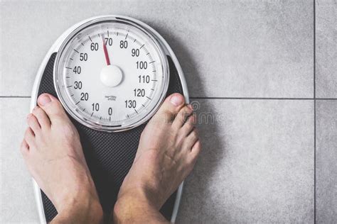 Close Up Weighing Scale Men Standing On Weigh Scales Stock Photo