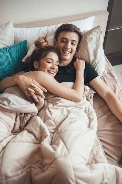 Premium Photo Upper View Photo Of A Caucasian Couple Lying In Bed Covered With A Blanket
