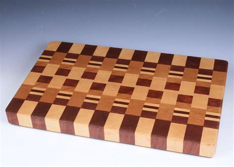 Beautiful 10 x 12 x 1 inch cutting board made from rock hard maple and exotic padauk hard woods. Exotic Wood End Grain Cutting Board 114 | ArtFestival.com