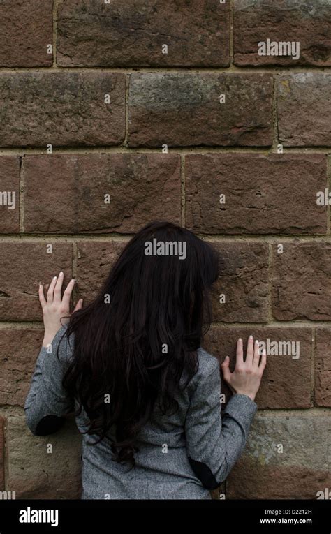 Woman Leaning Against The Wall Stock Photo Alamy