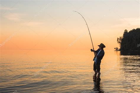 Fisherman On Lake At Sunset — Stock Photo © Scharfsinn 119668178