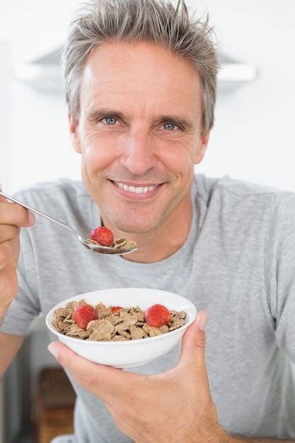 Premium Photo Happy Man Eating Cereal For Breakfast