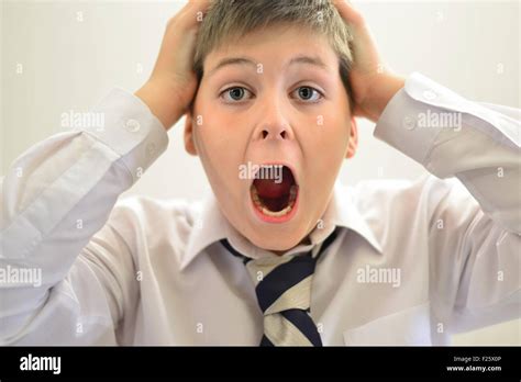 Teen Boy Screaming Holding His Hands Behind Head Stock Photo Alamy