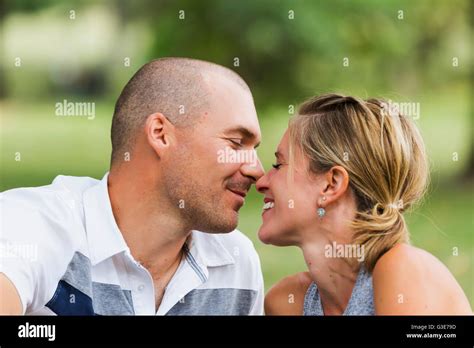 A Husband And Wife Kissing In A Park Edmonton Alberta Canada Stock
