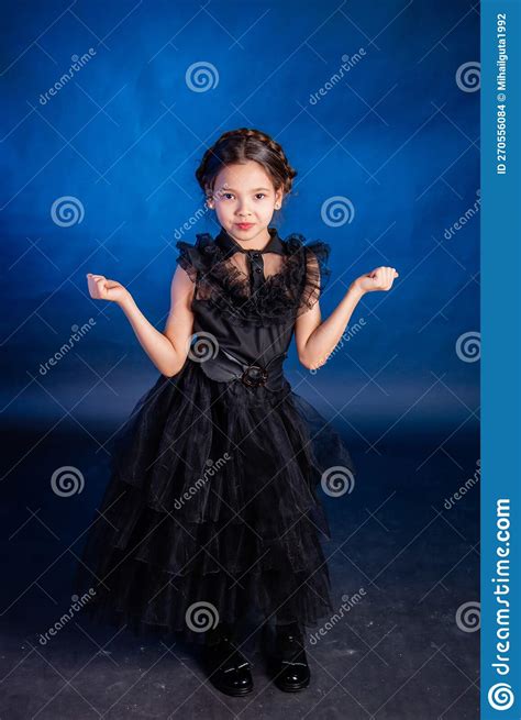 A Little Girl In A Black Dress With A Pigtail Hairstyle On Her Head