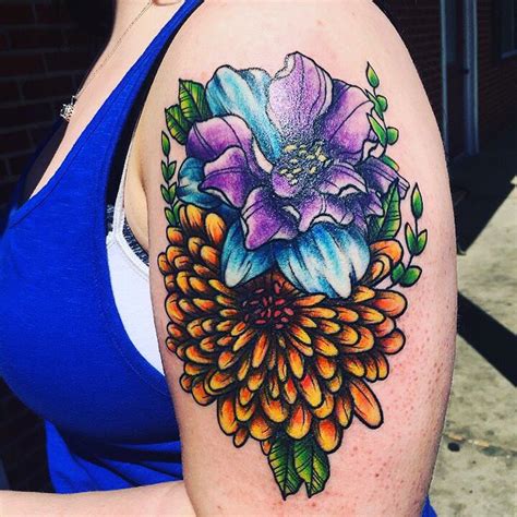 A Womans Arm With A Flower Tattoo On The Left Side Of Her Body