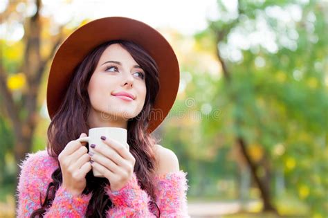 Photo Of Beautiful Young Woman With Cup Of Coffee Standing In Th Stock