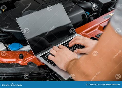 Partial View Of Auto Mechanic Working On Laptop With Blank Screen At