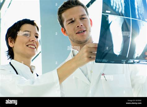 Close Up Of Two Doctors Examining An X Ray Report Stock Photo Alamy