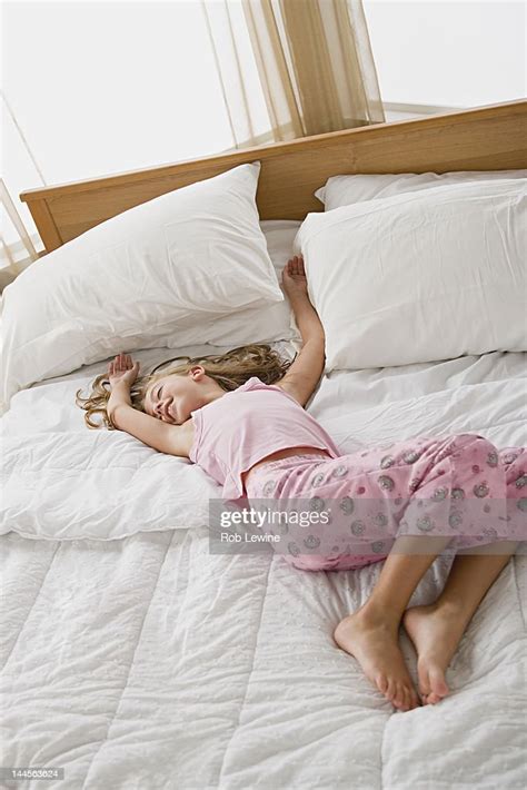 Usa California Los Angeles Girl Lying In Bed In Playful Pose High Res