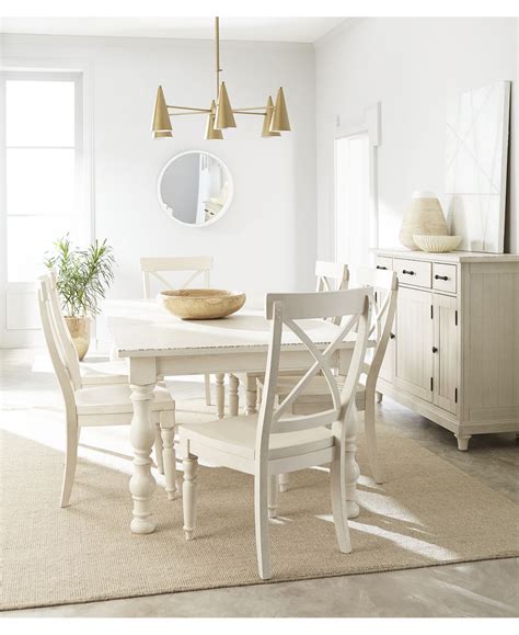 A collection of mismatched chairs and benches (enough to seat 22!) in this dining room makes for a come one, come all atmosphere. Furniture Aberdeen Worn White Expandable Dining Furniture ...