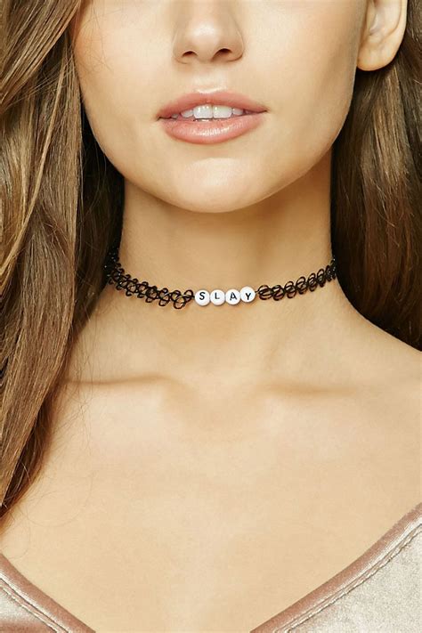 A Stretch Tattoo Choker Featuring Letter Beads Spelling Out The Word S