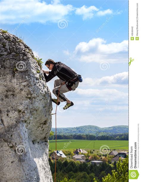 Extreme Rock Climbing Man On Natural Wall With Blue Sky Stock Photo