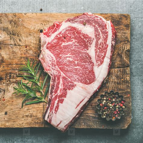 Raw Uncooked Beef Steak Rib Eye On Board Square Crop Stock Photo