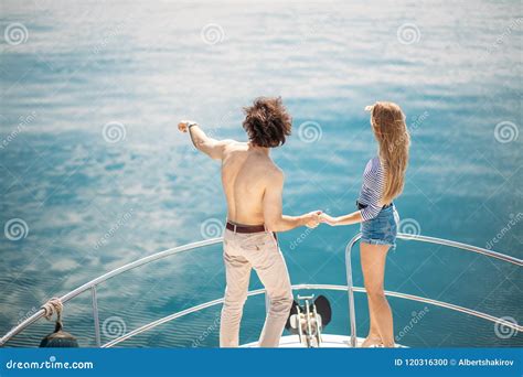 Passionate Lovers Dancing On Bow Of Deck While Sailing On Yacht Stock
