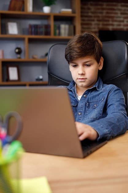 Premium Photo Portrait Of Young Boy Studying Remotely At Home Using