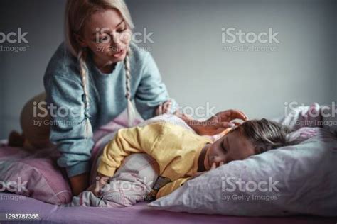 Mother Waking Up Child Daughter In Bedroom Stock Photo Download Image