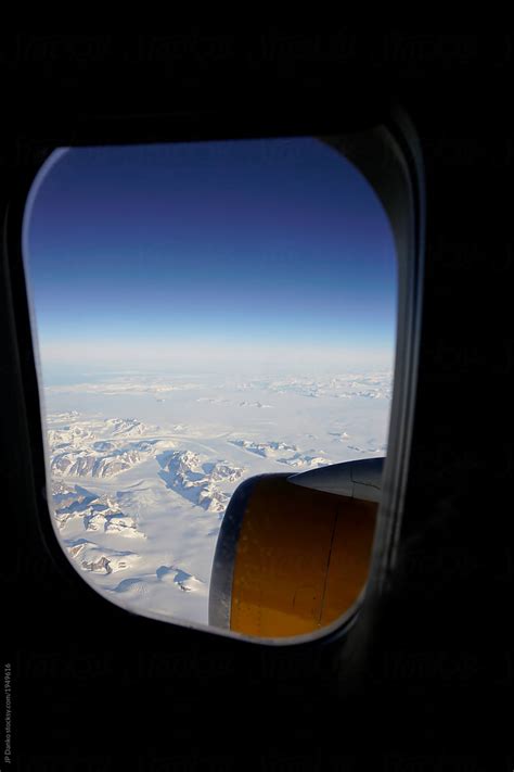 View Of Frozen Landscape Of Greenland Through Window Of Airplane Del