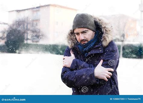 Portrait Of Man Feeling Very Cold And Shivering In Winter Stock Image