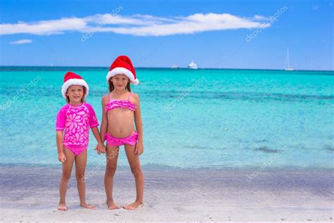 Маленькие девочки в шляпах Санты во время летних каникул стоковое фото d travnikov