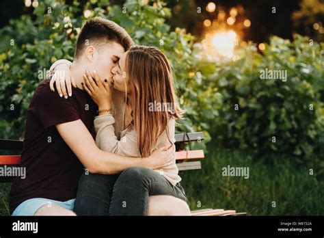 Young Couple Kissing On Park Bench Hi Res Stock Photography And Images