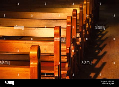 Rows Of Church Benches Sunlight Filtered Through The Stained Glass