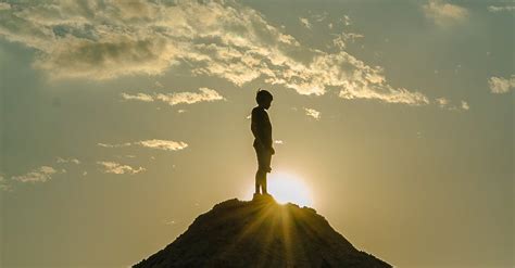 Silhouette Of A Man Standing On A Mountain · Free Stock Photo