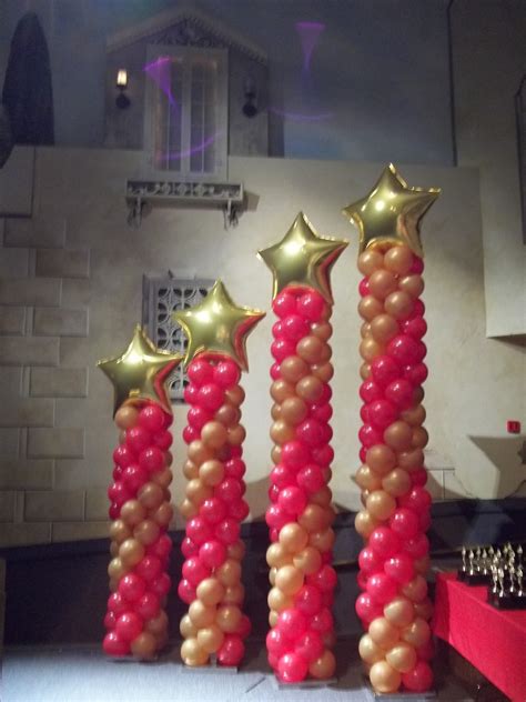 Dramatic Red And Gold Balloon Columns With Star Toppers Great For An