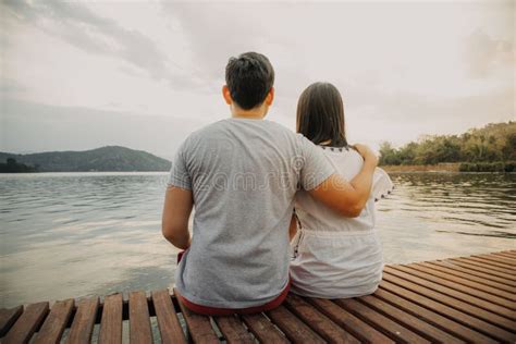 Lover Couple Hold Together And Admire The Romantic Beautiful Lake