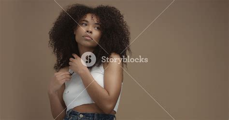 Mixed Race Black Woman Portrait With Big Afro Hair Curly Hair In Beige Background Royalty Free