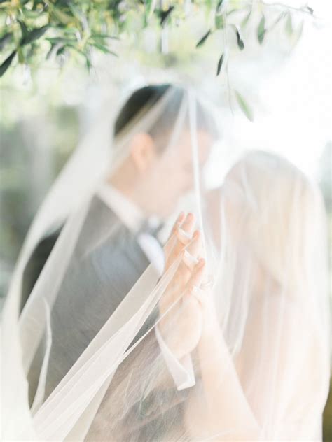 Bride And Groom Holding Hands Under Wedding Veil Itgirlweddings