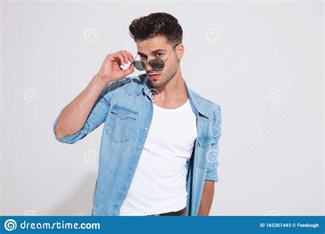Charming Casual Man Taking Off His Sunglasses And Looking Forward Stock Image Image Of
