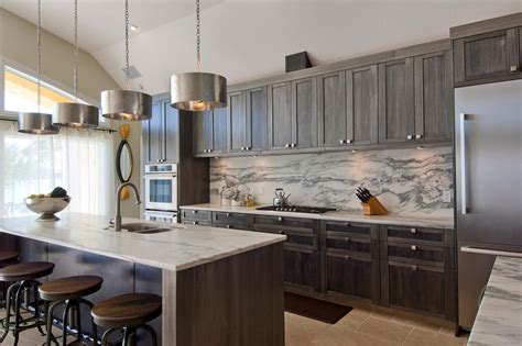 Here, mckinley architects pairs a stunning blue tile backsplash with crisp white cabinetry. Gray Cabinets & Marble Backsplash in Contemporary Kitchen ...