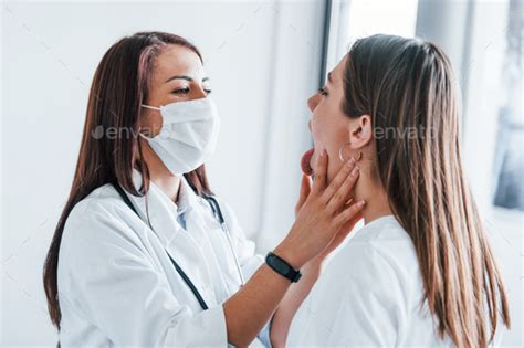 Checking Lymph Nodes And Throat Young Woman Have A Visit With Female