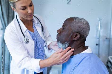 Caucasian Female Doctor Palpating Lymph Nodes Of African American Male