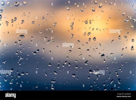 Raindrops On A Window With A Sunset Sky In The Background Clear