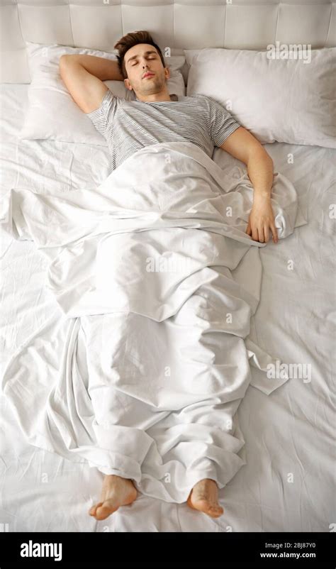 Young Man Sleeping Alone In White Big Bed Stock Photo Alamy