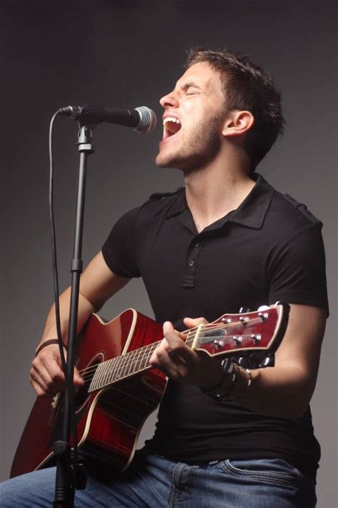 Premium Photo Man Singing And Playing On A Guitar Music Photoshoot