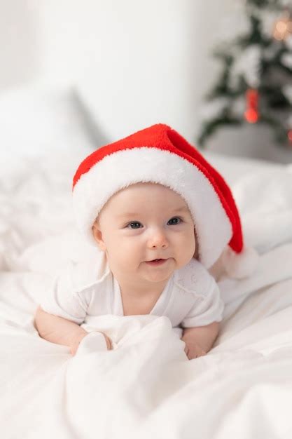 Premium Photo Cute Baby In Santa Hat At Home In Bed The First New