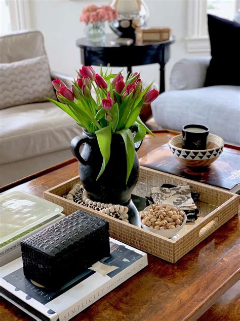 A stack of books about shabby chic decorating is accented by a vintage white bird and a simple vase of robin's eggs. list of ideas to decorate your coffee table with ...