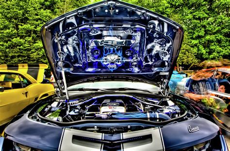 Cars get wet under the hood when it rains. Under the Hood Photograph by Dave Hahn