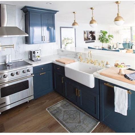 They're also easy to stick with over time, as they can adapt to a variety of styles and colours. Navy blue cabinets with gold accents | Home decor kitchen ...